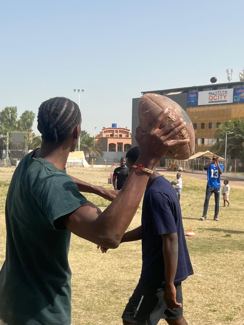 Players practicing football passing outdoors