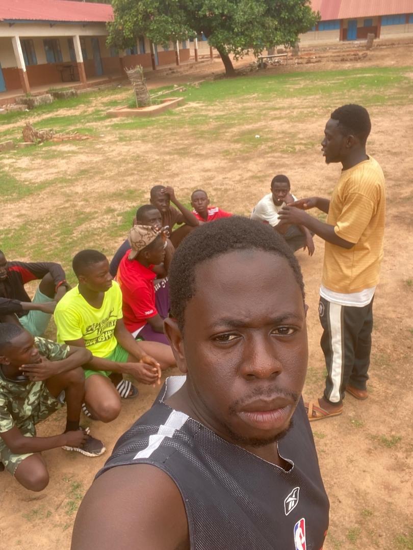 A group discussion beside the school buildings