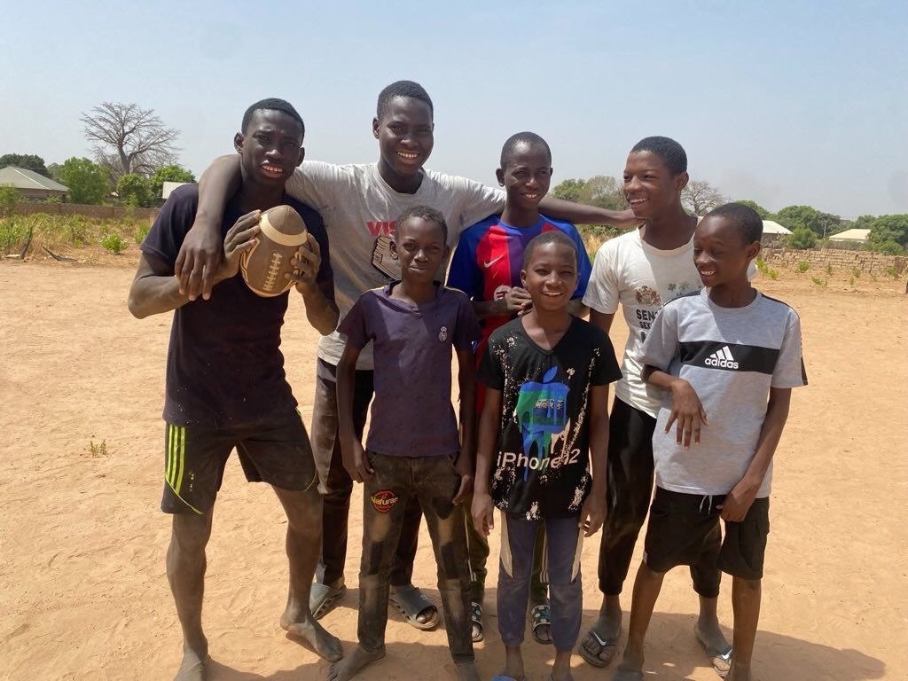 Friends together with a football