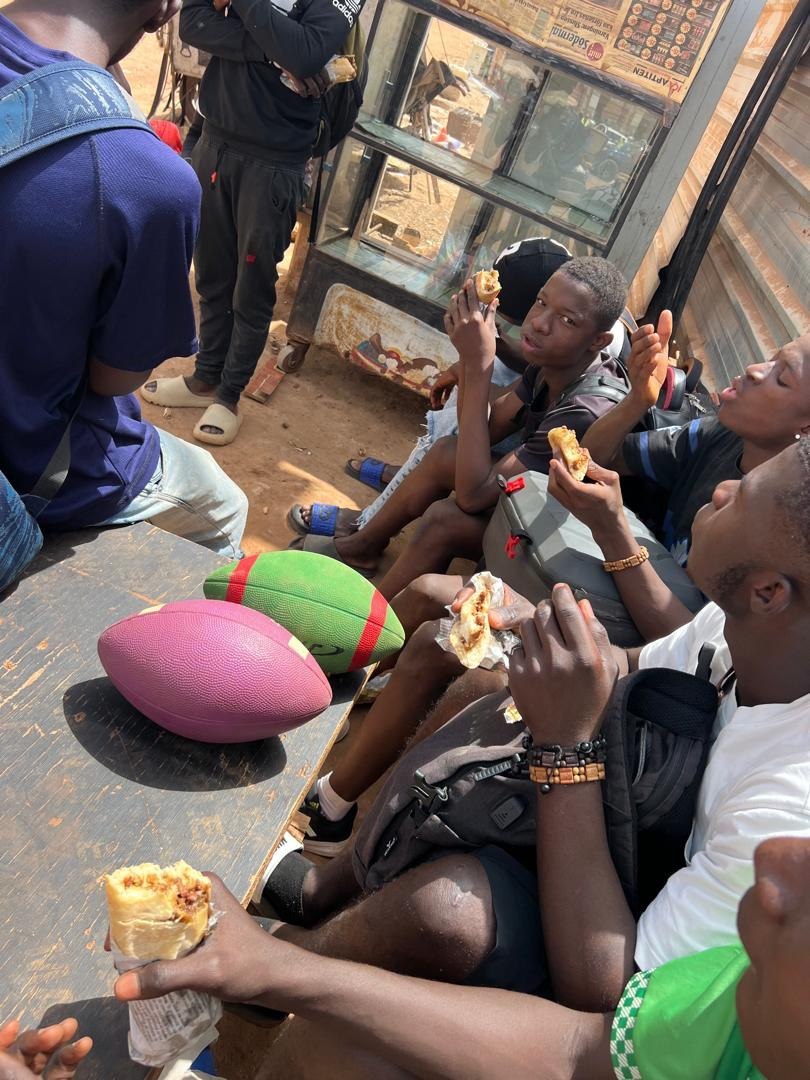 Sharing a meal, with footballs close by