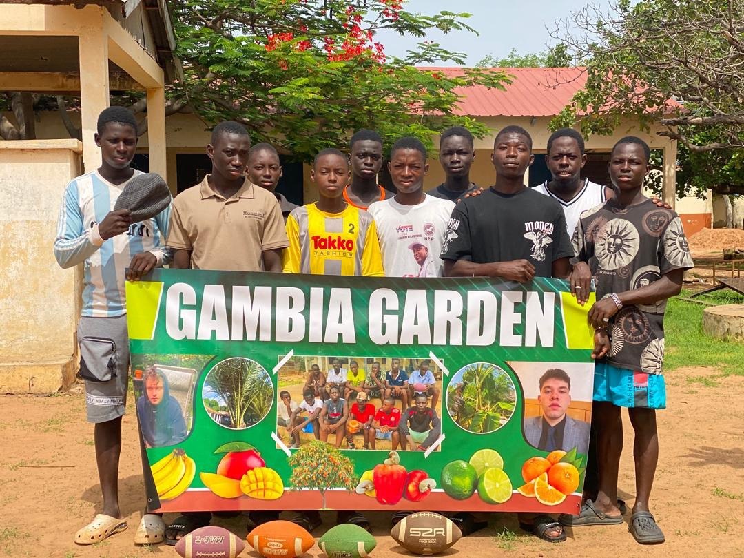 Young players with the Gambia Garden banner