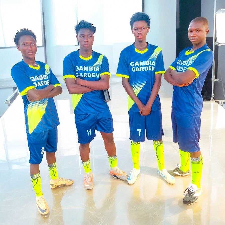 Four teammates in Gambia Garden jerseys